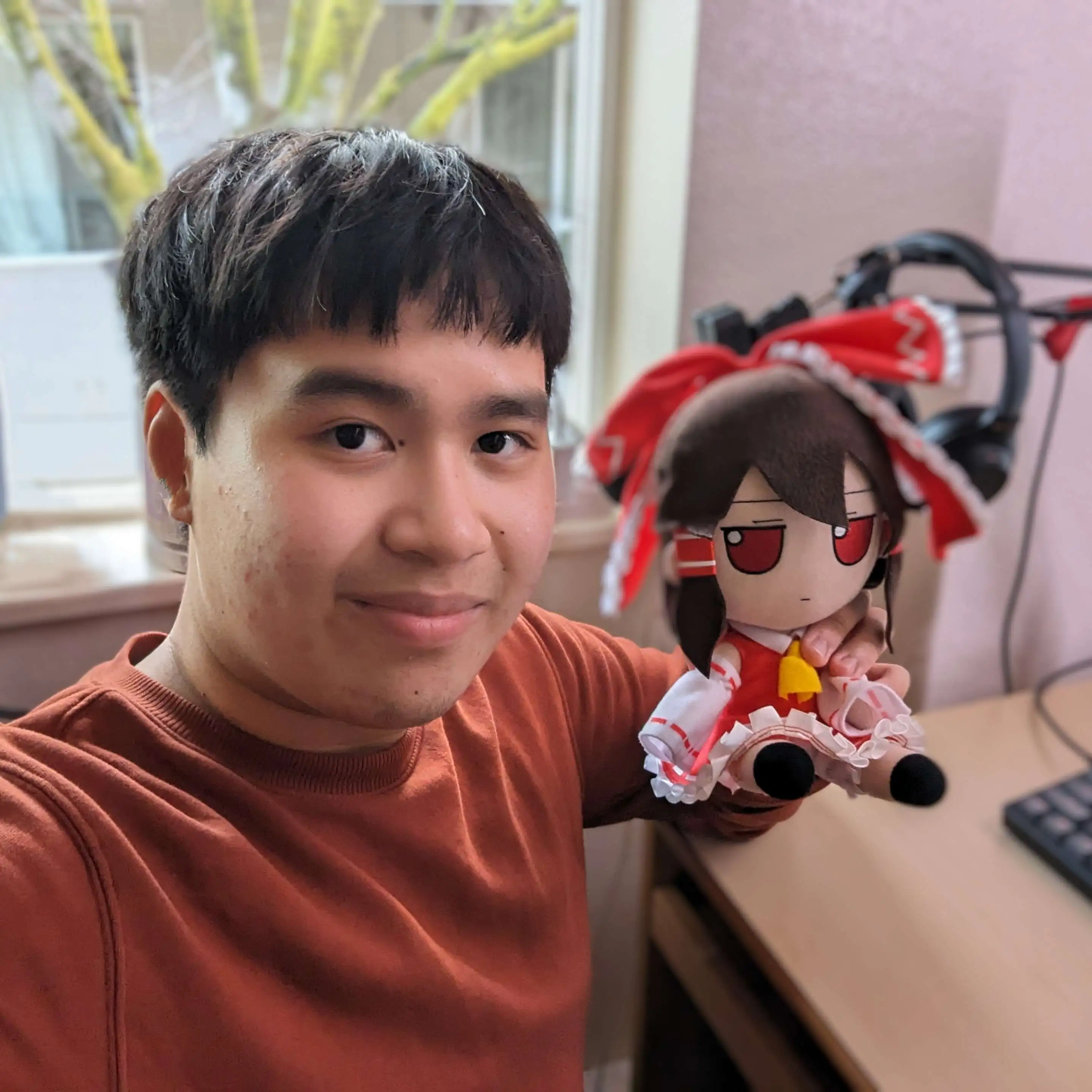 William Le holding a Reimu fumo